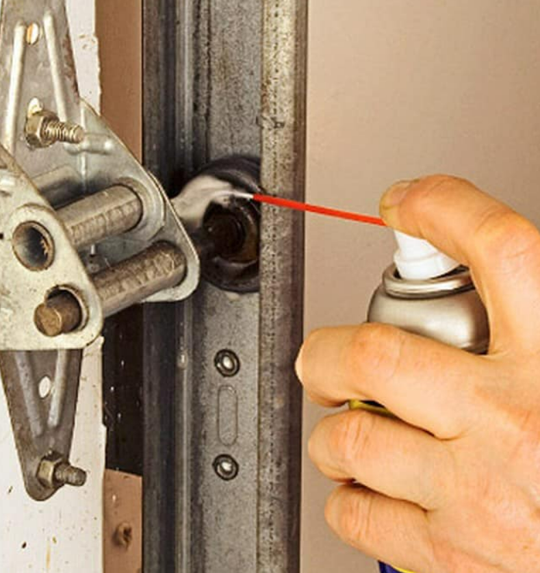 a technician repairing a noisy garage door in Jupiter, FL. The garage door is partially open, and the technician is adjusting the hinges to ensure smooth and quiet operation. This repair service is part of the comprehensive solutions offered by Garage Door Repair Services in Jupiter, FL.