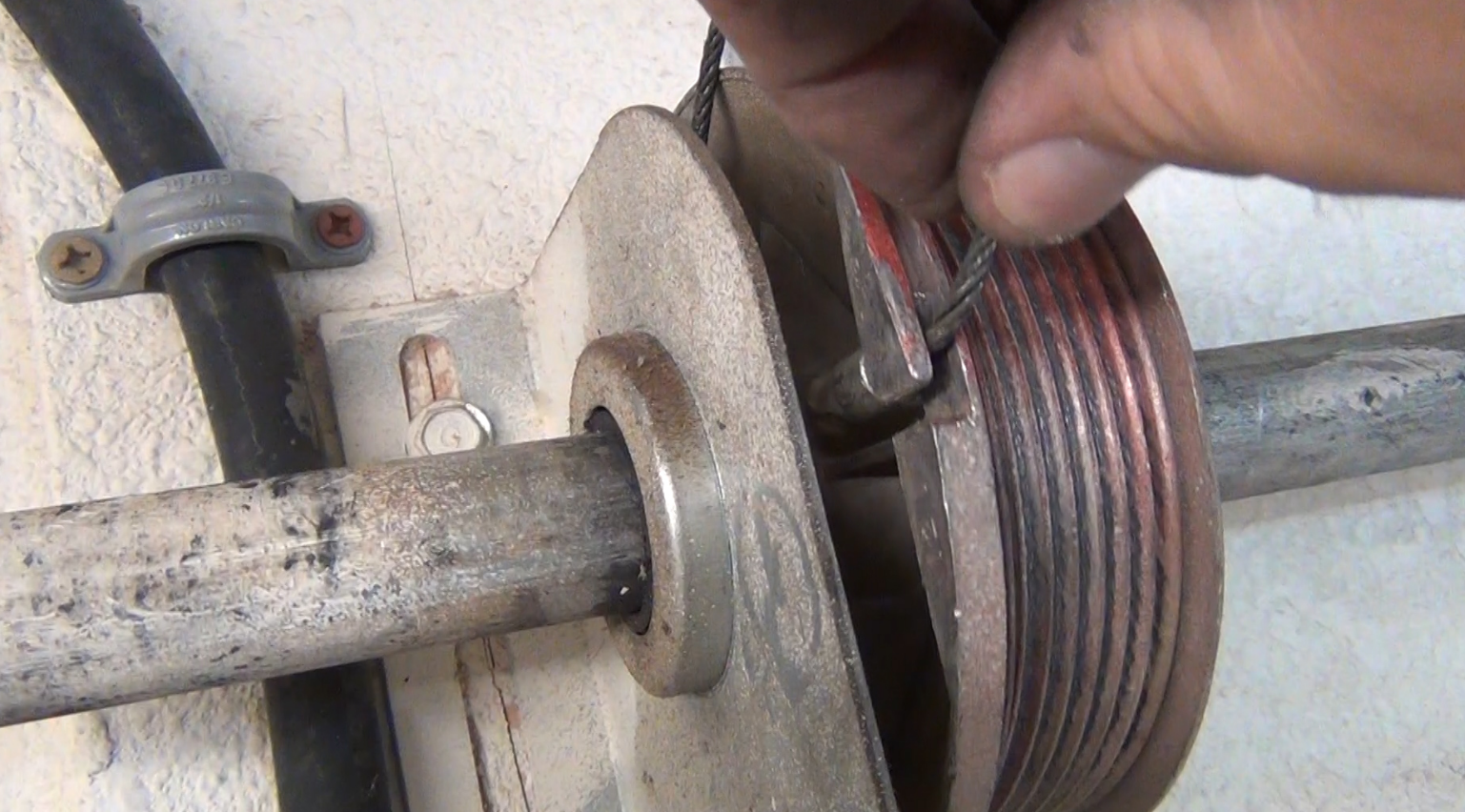 Technician performing garage door cable repair in Jupiter, FL - ensure smooth operation and safety with expert services.