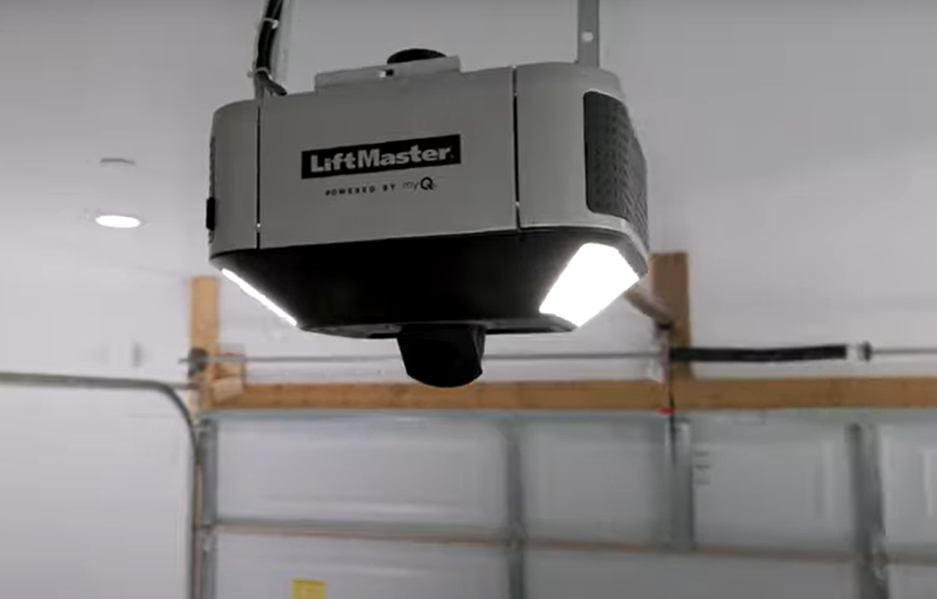 Close-up of a technician repairing a garage door opener in Jupiter, FL, showcasing tools and parts, ideal for Garage Door Repair Services.