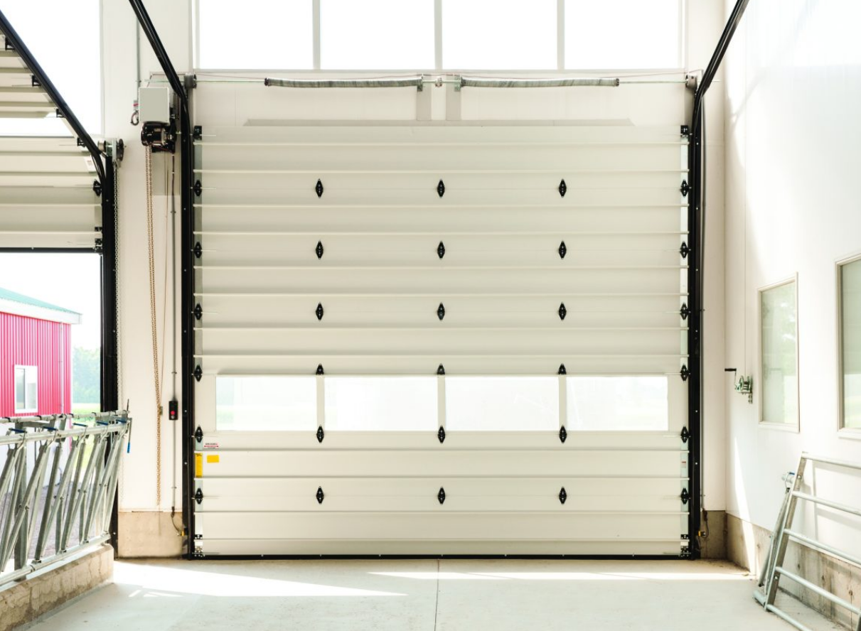 a professional technician performing a commercial garage door repair for a business in Jupiter, FL, showcasing high-quality service and expertise.