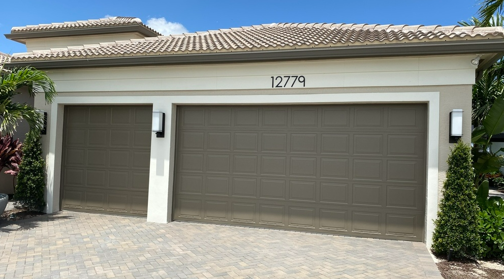 a professional technician repairing a garage door in Jupiter, FL, showcasing top-notch garage door repair services.