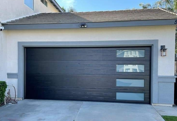 a skilled technician repairing a residential garage door with precision tools in Jupiter, FL. Highlighting professional garage door repair services.
