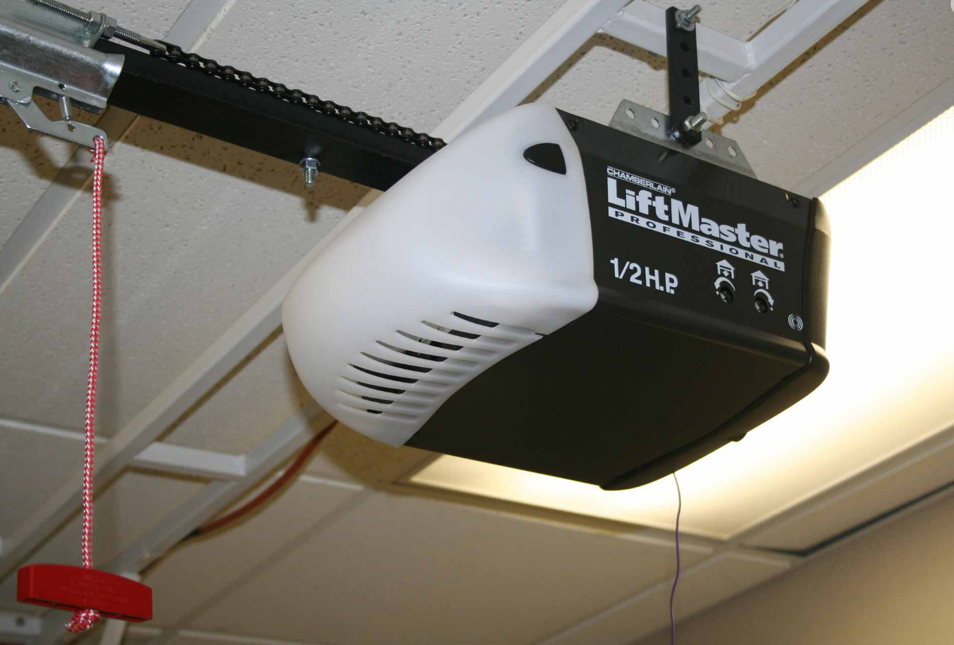 a technician fixing a garage door opener, highlighting expert repair services in Jupiter, FL.