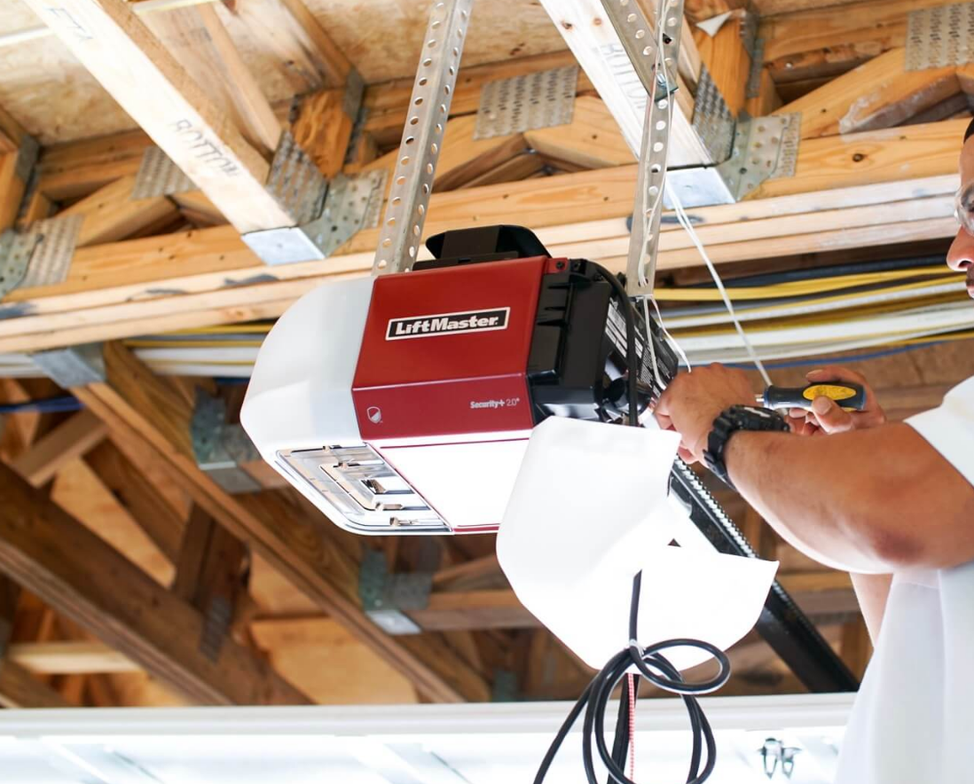 a technician repairing a garage door opener, showcasing tools and equipment used in professional garage door services in Jupiter, FL.