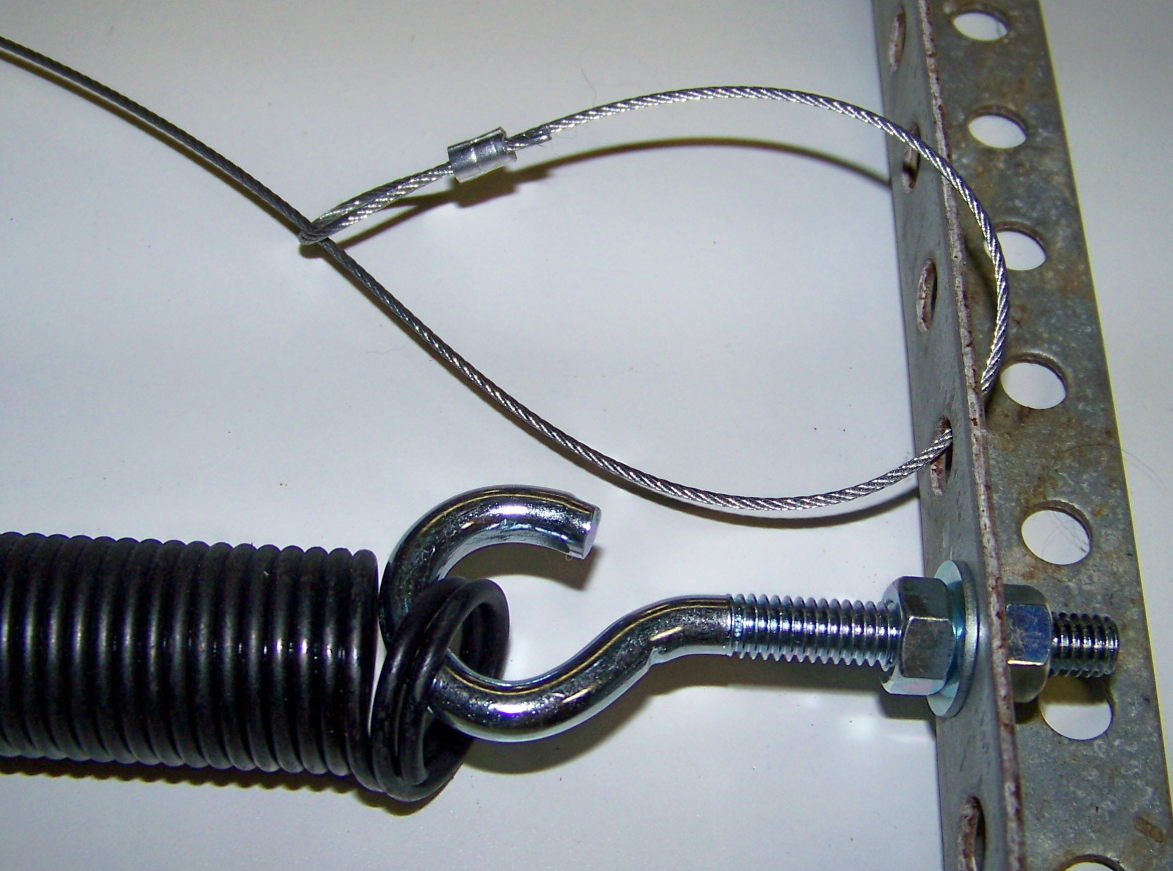 a professional technician performing garage door spring repair in Jupiter, FL. The technician is using specialized tools to ensure safe and accurate repair, providing reliable garage door service. The background features the exterior of a residential garage, highlighting the focus on quality repair services in the Jupiter area.