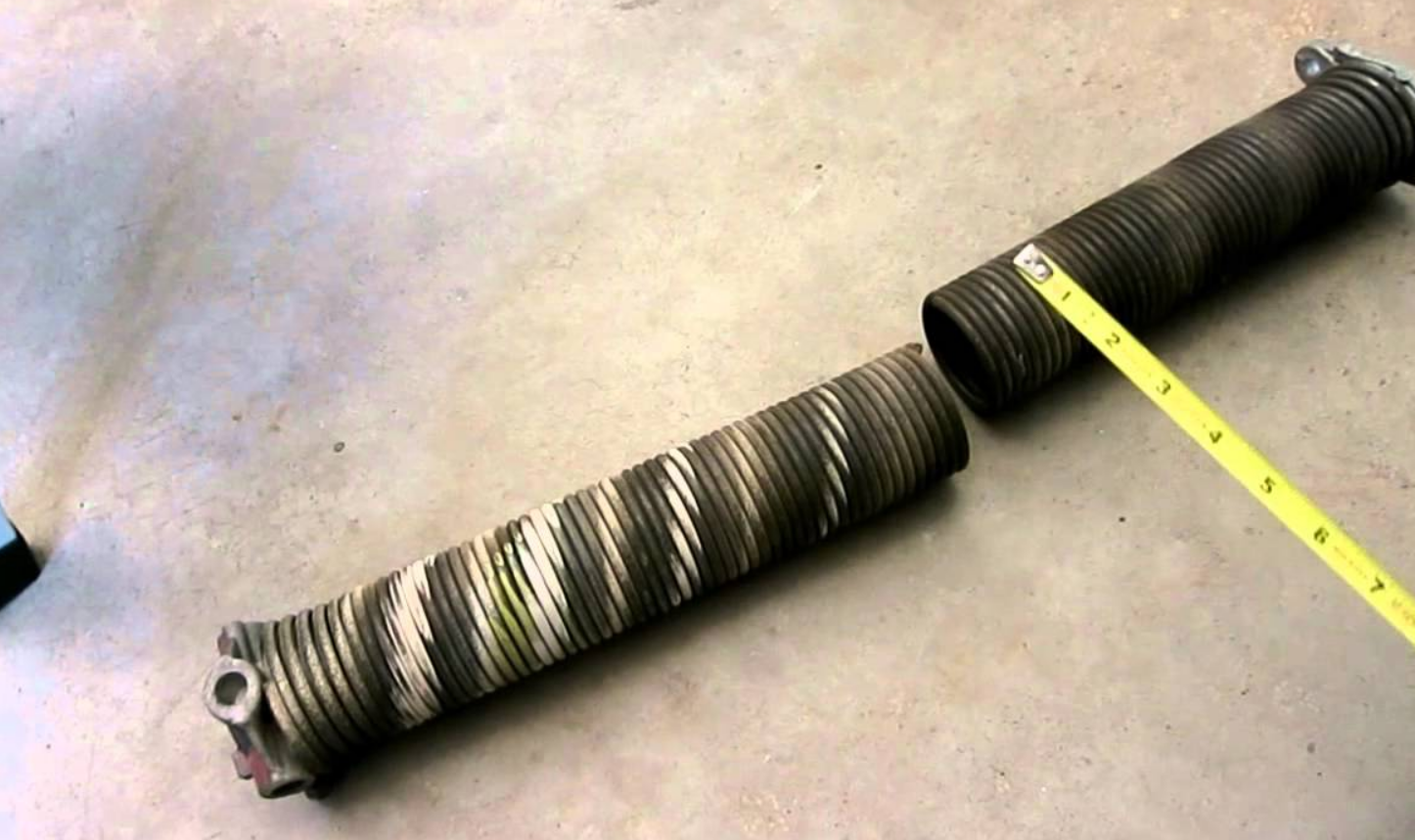 Detailed close-up image of a technician performing garage door spring repair on a residential garage door in Jupiter, FL.