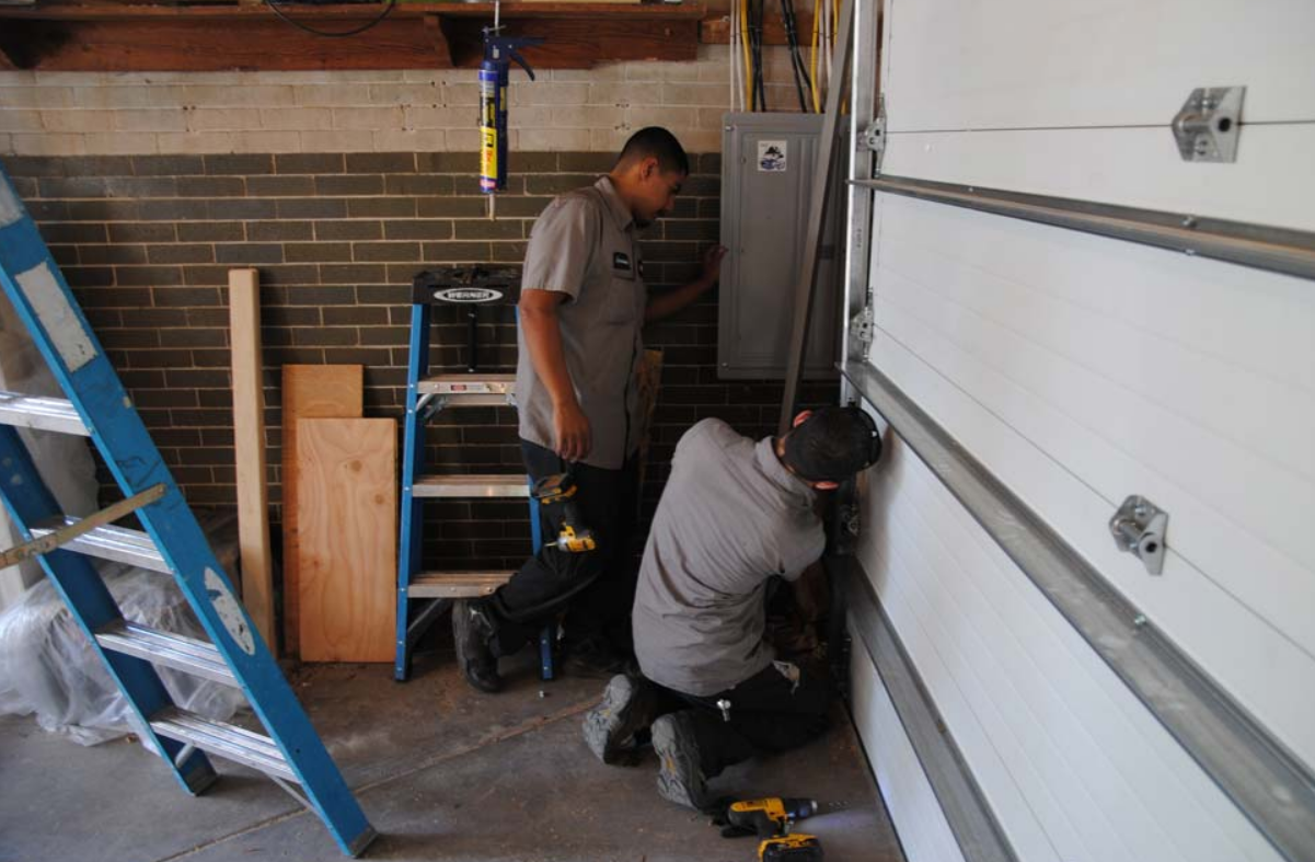 Alt text: "Local garage door repair service in Jupiter, FL showcasing expert technicians fixing a residential garage door with precision and care.