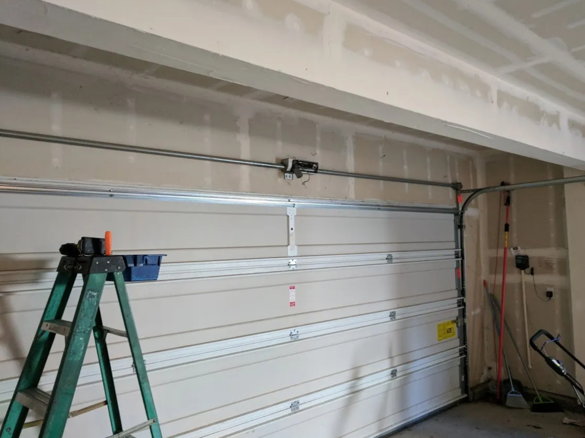 Professional technician repairing a garage door in Jupiter, FL - Garage Door Repair Services offers expert solutions for all your garage door repair needs.
